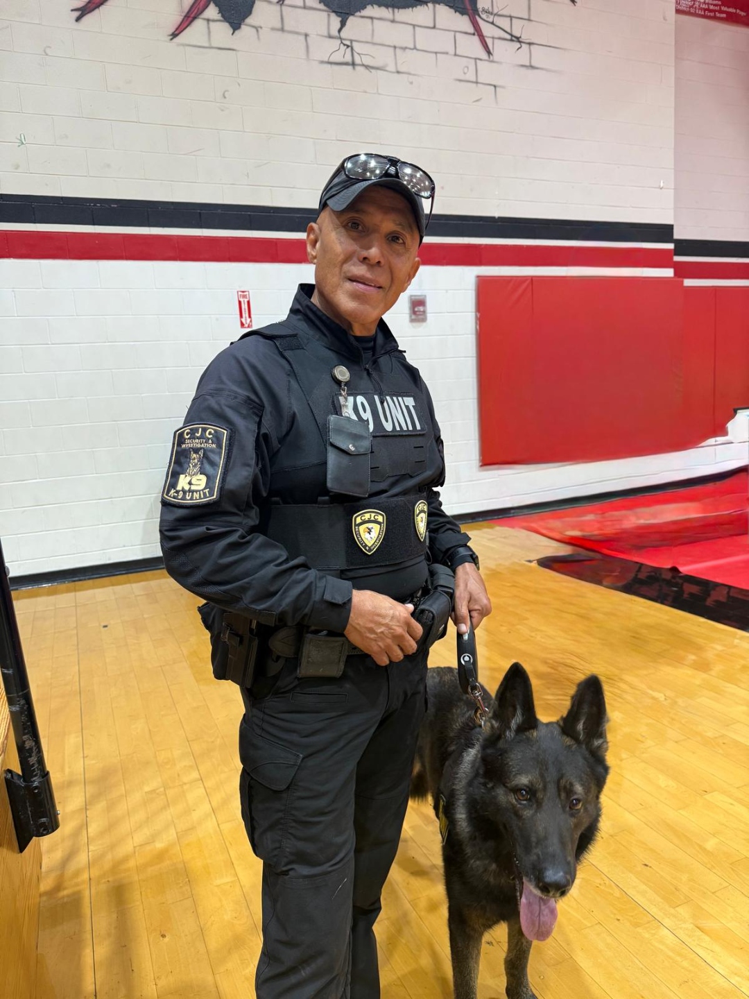 CJC Security K9 Unit handler with German Shepherd at school